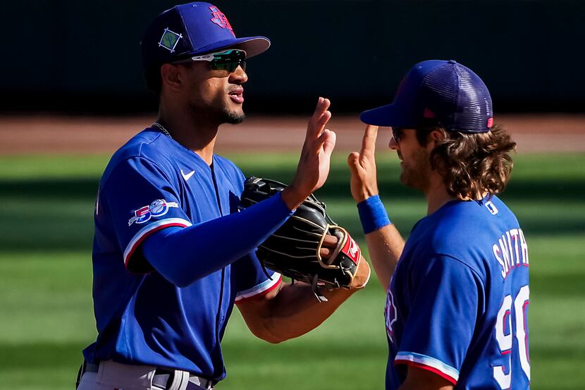 Texas Rangers outfielder Bubba Thompson celebrates with infielder Josh Smith after a victory...