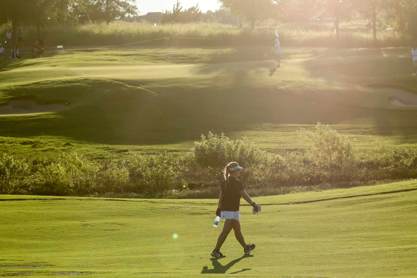 Amateur golfer Avery Zweig, 14, of McKinney walks the No. 8 fairway during the second round...