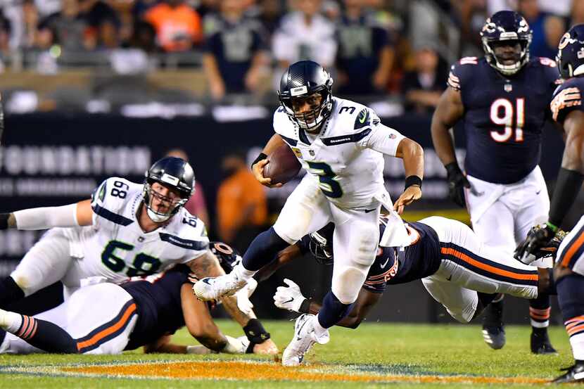 CHICAGO, IL - SEPTEMBER 17:  Quarterback Russell Wilson #3 of the Seattle Seahawks carries...