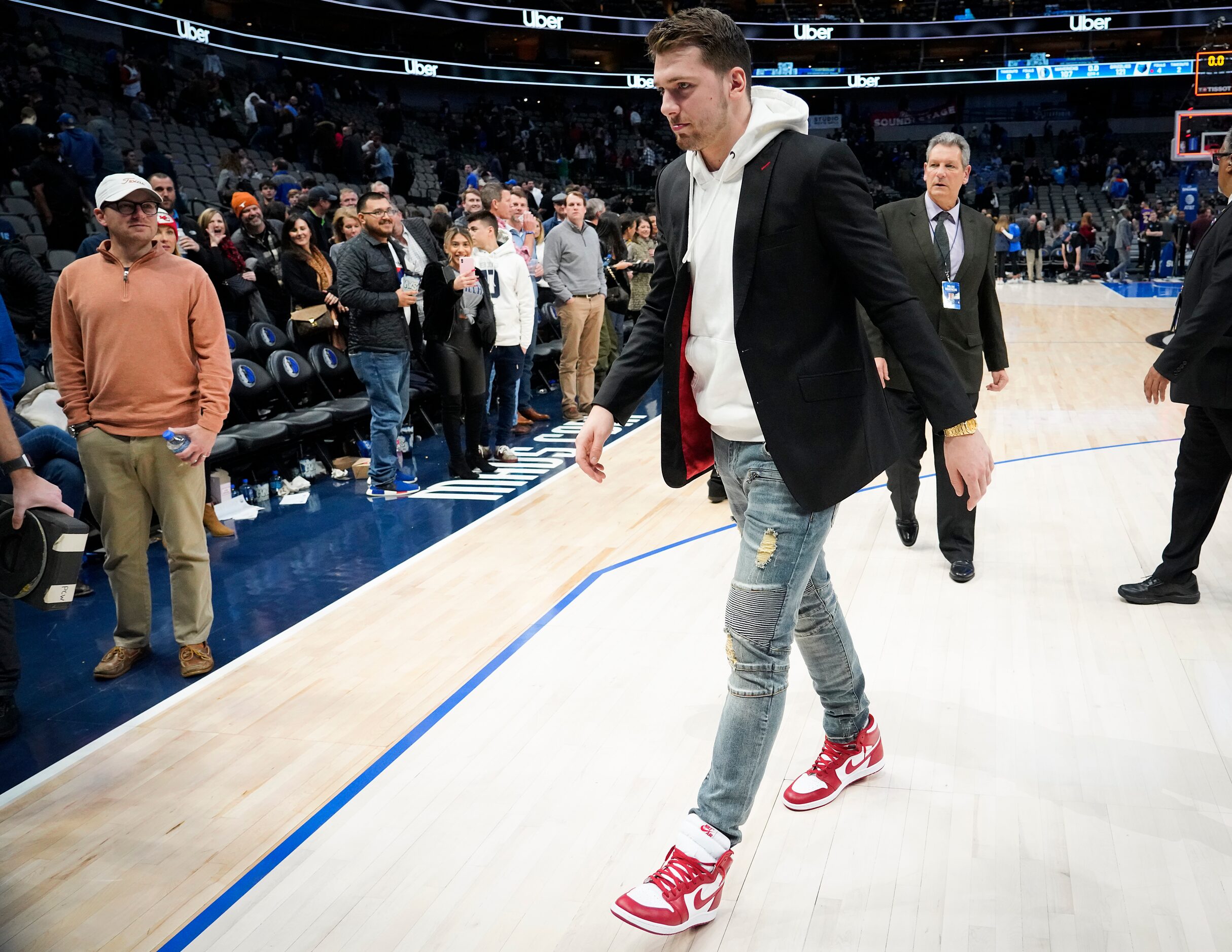 Injured Dallas Mavericks guard Luka Doncic walks off the court after a loss to the Memphis...