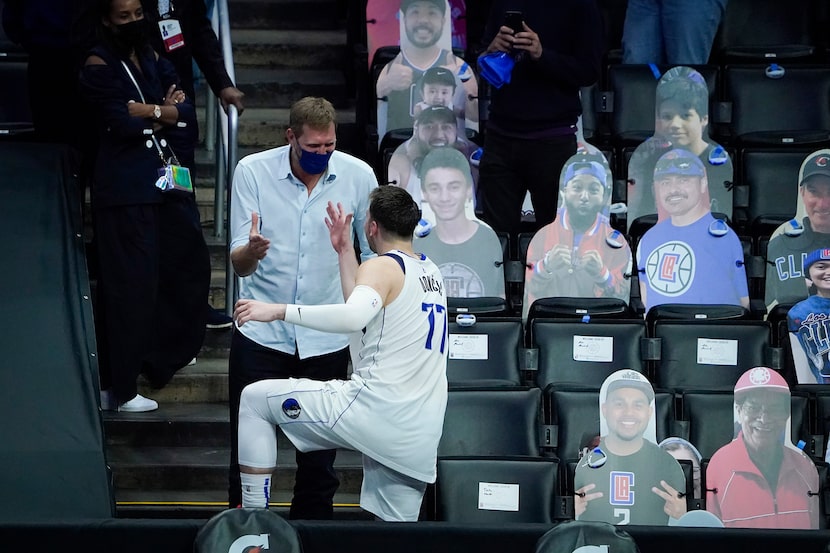 Dallas Mavericks guard Luka Doncic (77) celebrates with Dirk Nowitzki after the Mavericks...