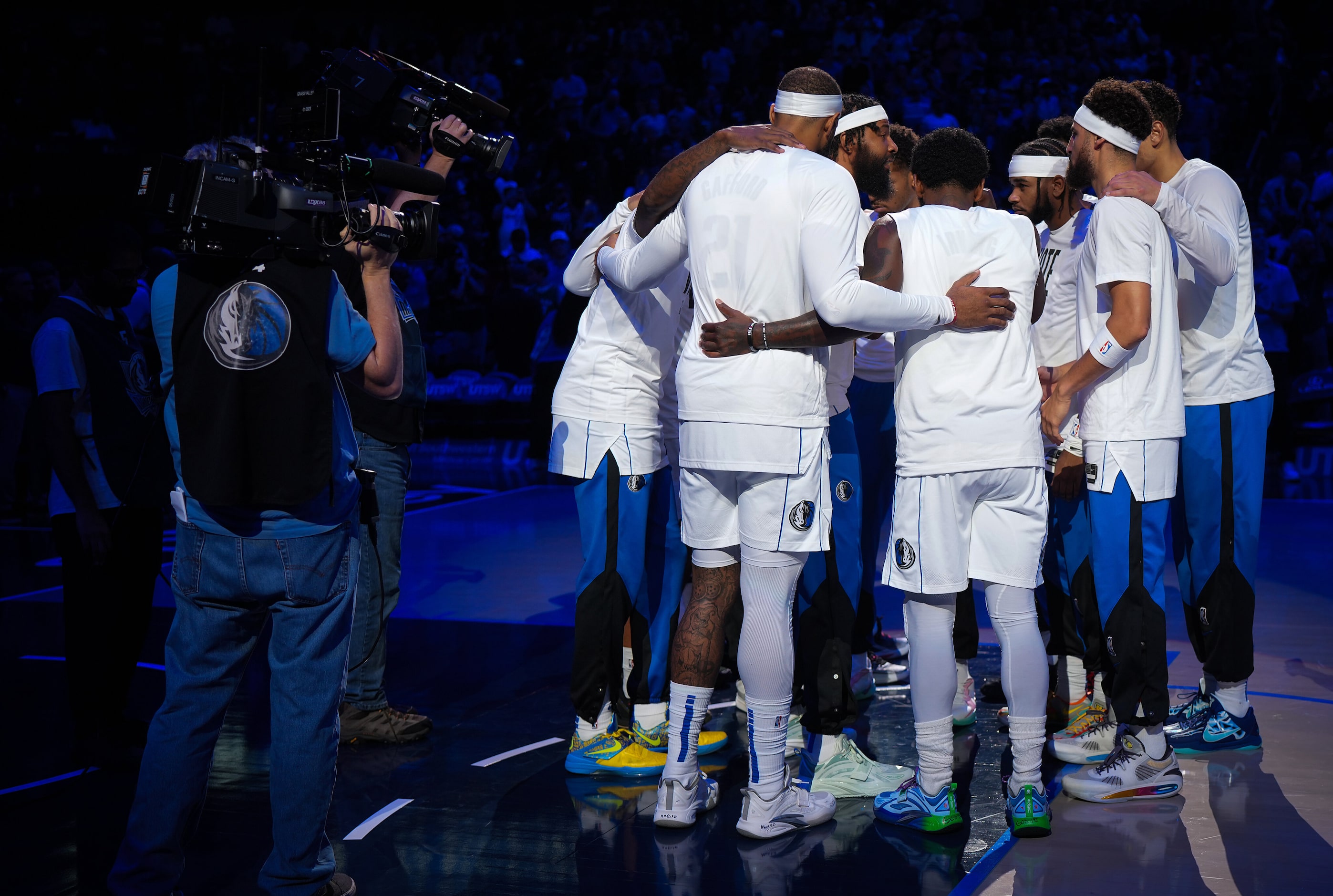 Dallas Mavericks players huddle before an NBA basketball game against the Indiana Pacers at...