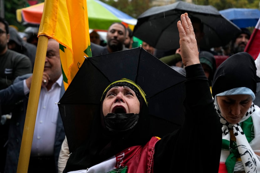 An Iranian woman cries during a gathering in support of Lebanon's militant Hezbollah group...