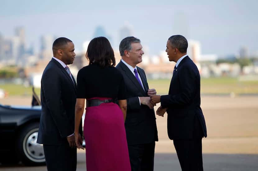 President Barack Obama and first lady Michelle Obama greeted Dallas Mayor Mike Rawlings and...