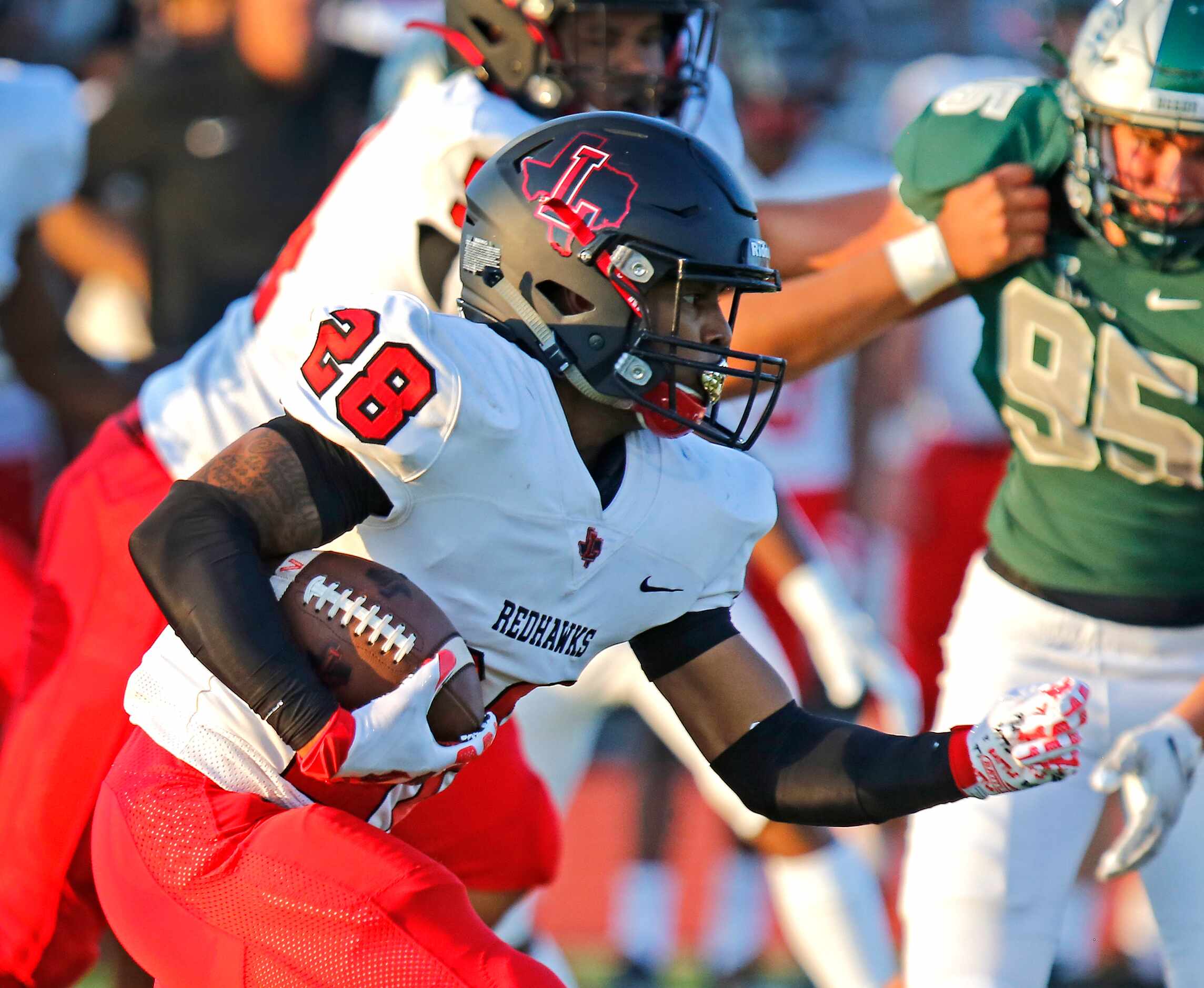 Liberty High School running back Cartier Beverly (28) carries the ball during the first half...