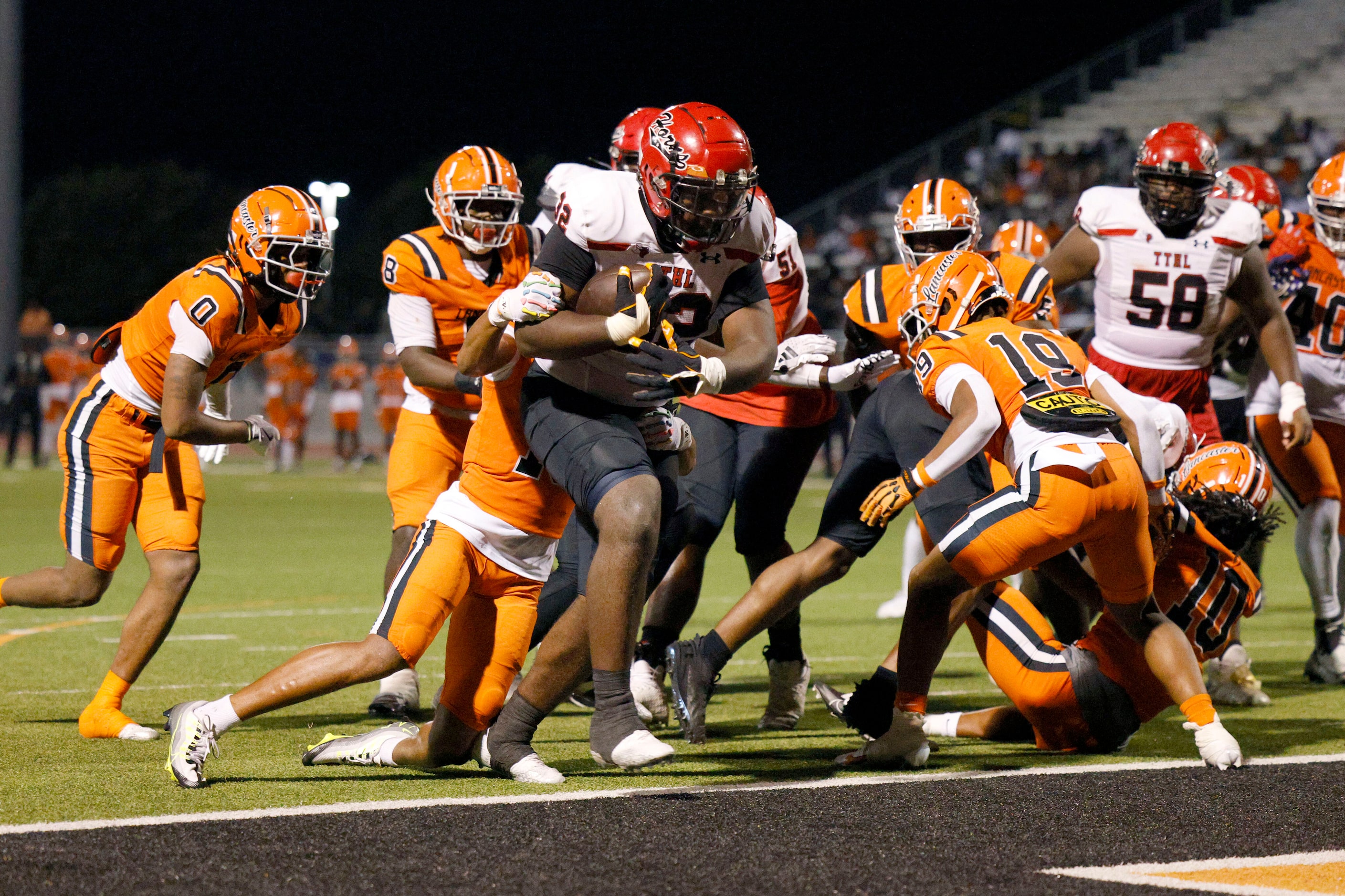 Cedar Hill running back Jalen Brewster (32) powers through the line of scrimmage for a...