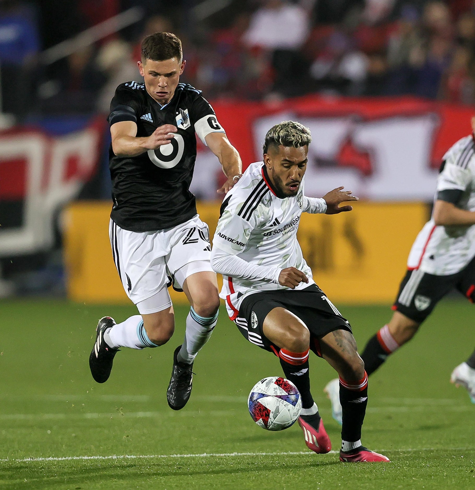 FC Dallas attacker Jesus Ferreira, (right) steals the ball away from Minnesota United...