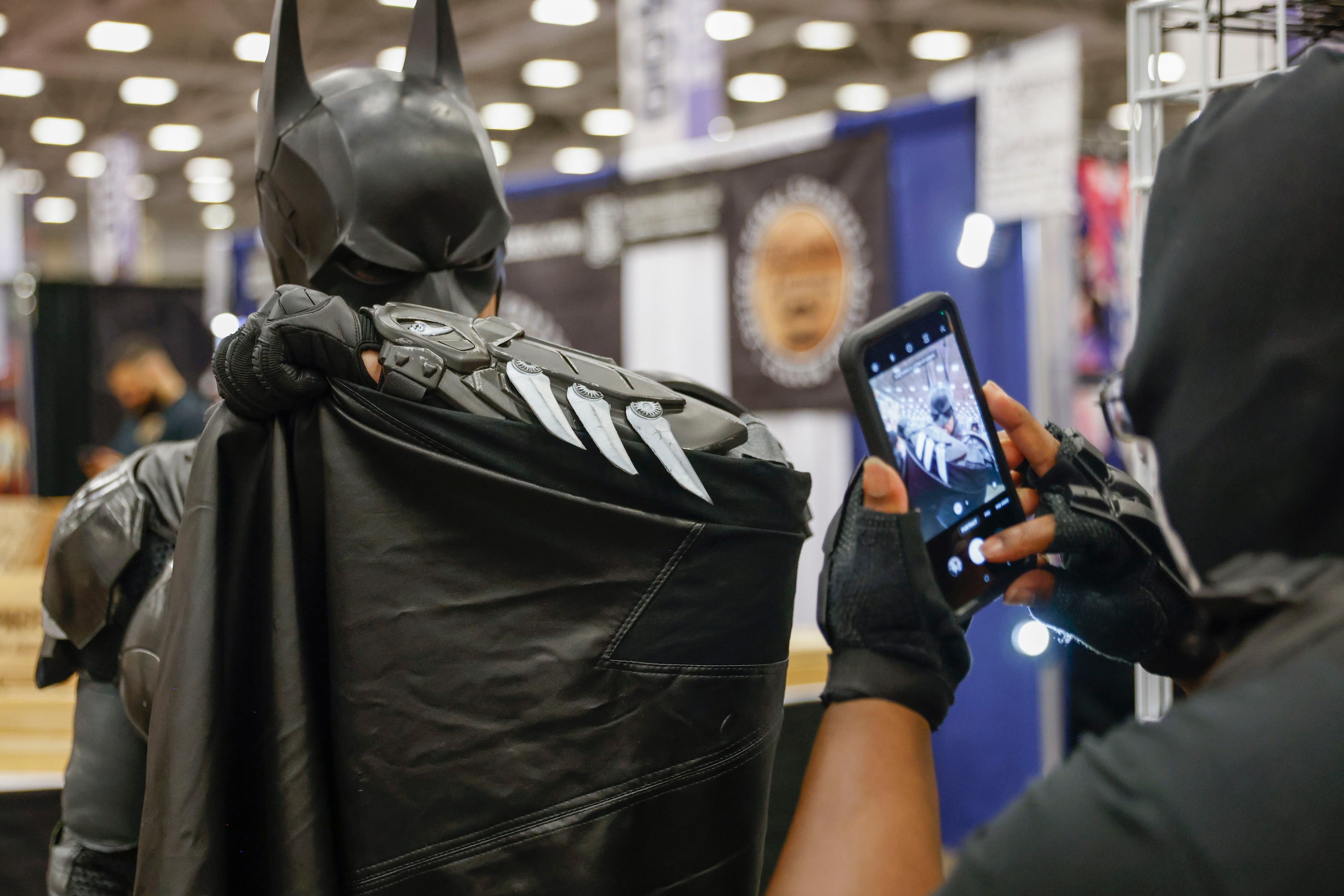 Will Ellis dressed as Batman pose for a photo for Brian Verrett during Fan Expo Dallas on...