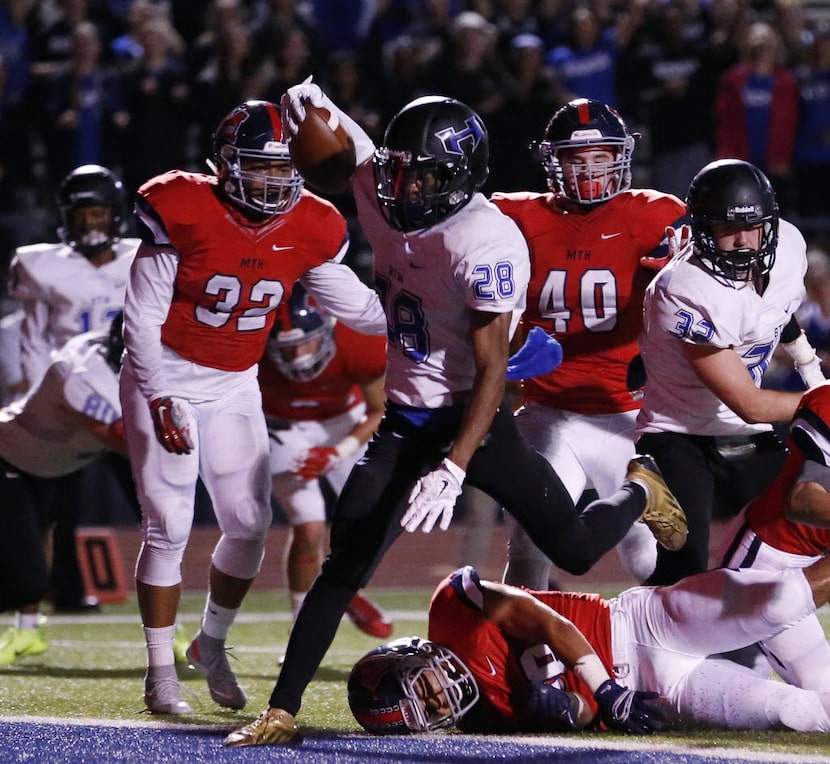 Hebron running back Derian Vaughn (28) scores a rushing touchdown to make the score 13-7 in...