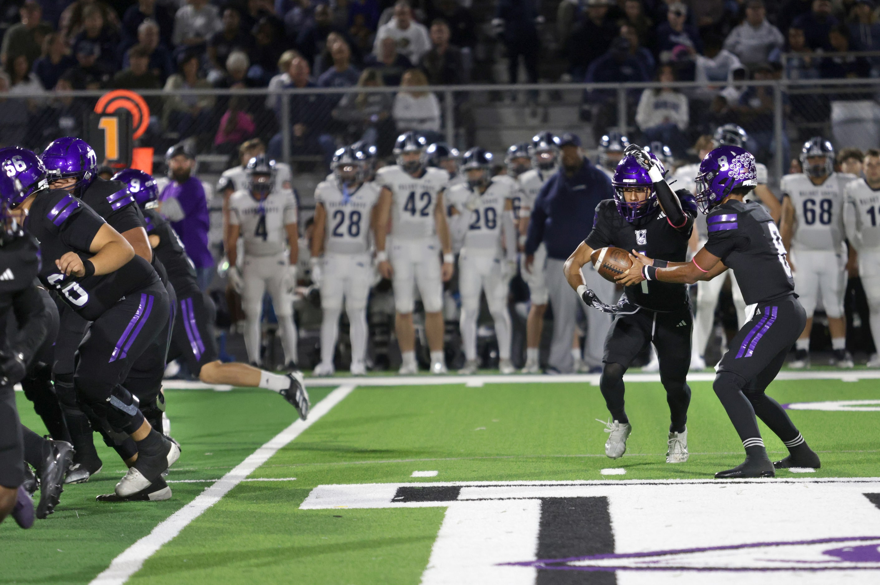 Anna player #1 Edward Chumley receives a handoff from #8 Ziondre Williams during the Prosper...