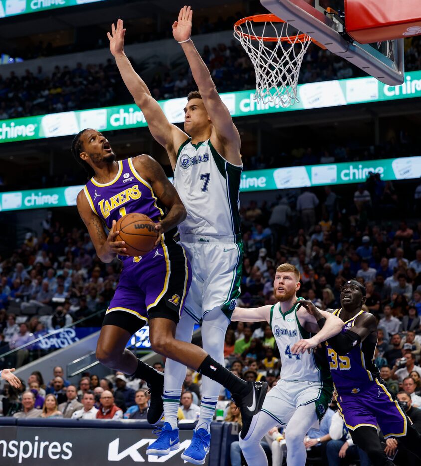 Los Angeles Lakers forward Trevor Ariza (1) attempts to shoot past Dallas Mavericks center...