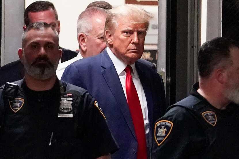 FILE - Former President Donald Trump is escorted to a courtroom, April 4, 2023, in New York....