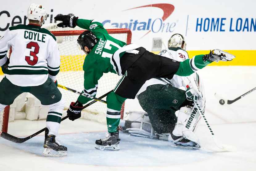 Dallas Stars center Devin Shore (17) is knocked off his feet in front of Minnesota Wild...