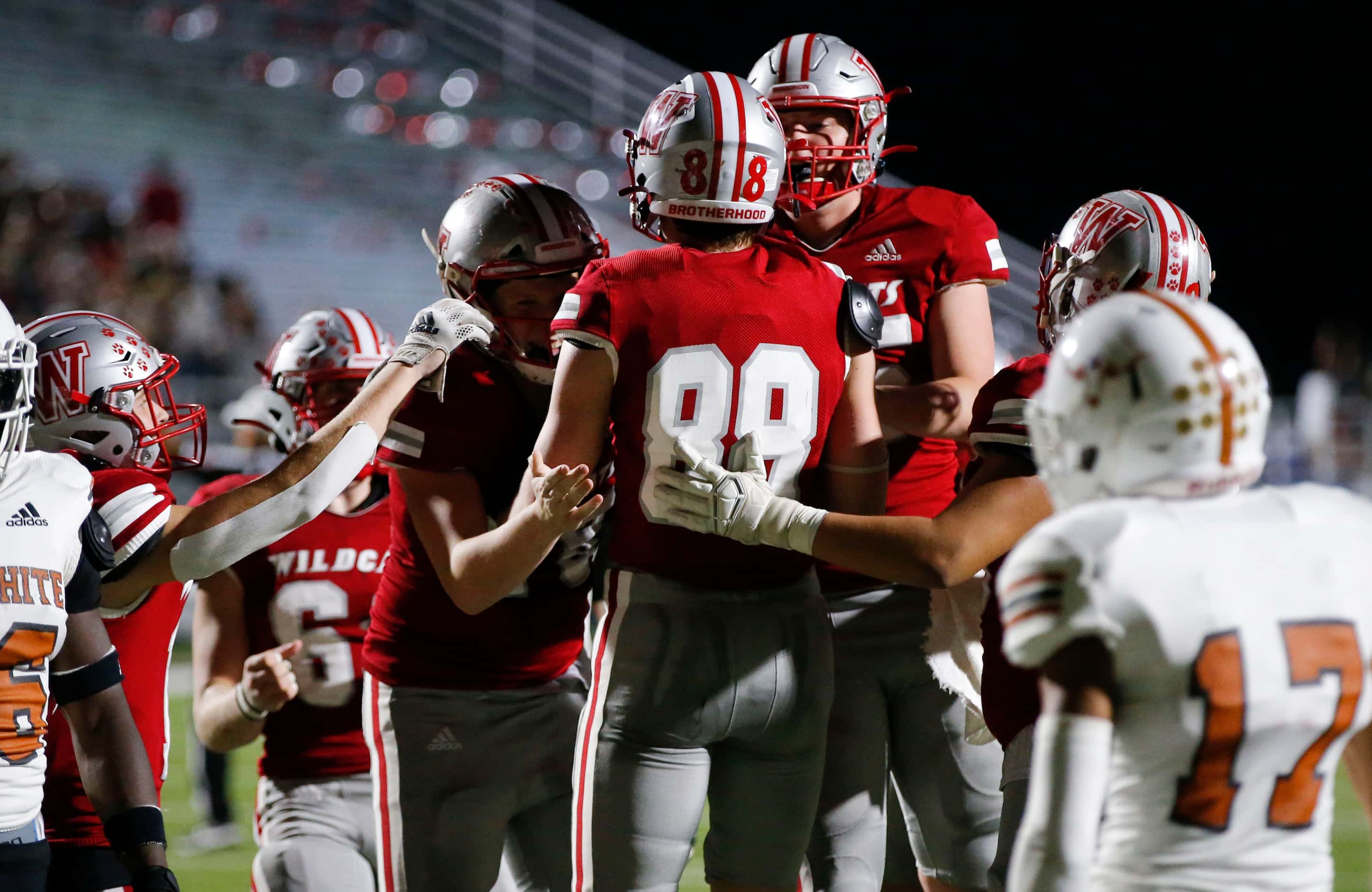 Woodrow Wilson senior wide receiver Noah Calhoun (88) is congratulated by teammates after...