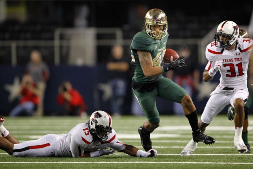 Baylor Bears wide receiver Levi Norwood (42) avoids the tackle by Texas Tech Red Raiders...