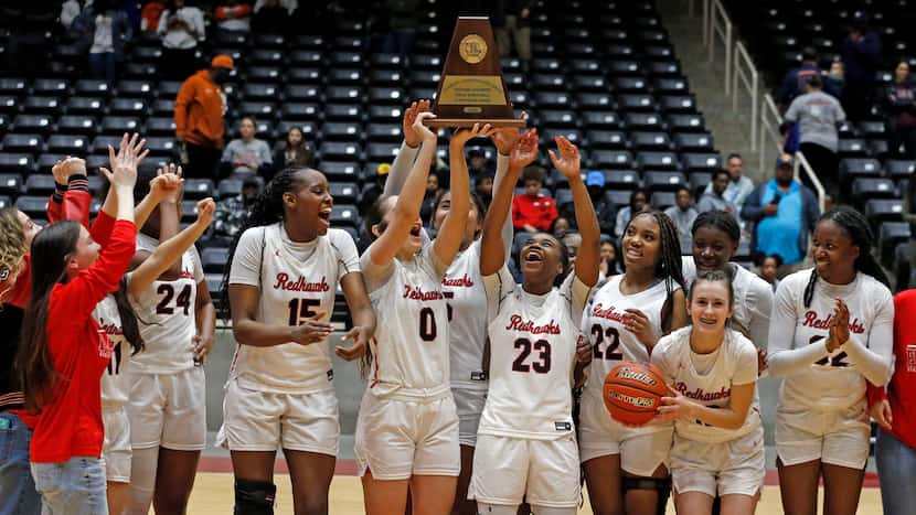 Frisco Liberty High’s G Jezelle Jolie Moreno (0) holds the championship trophy high, and she...