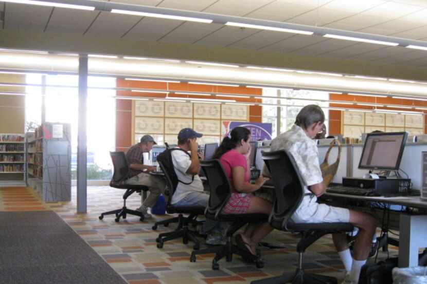Patrons access computers at the Dallas Public Library.