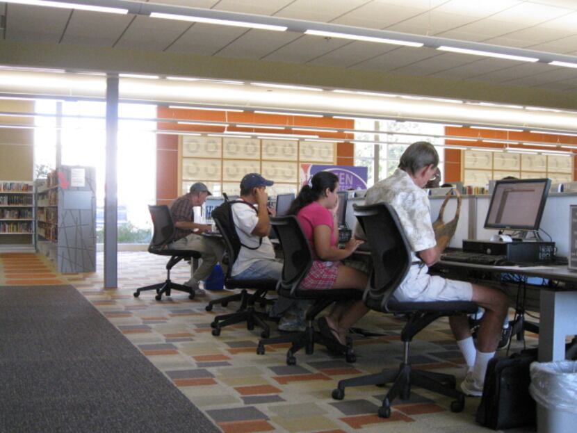Patrons access computers at the Dallas Public Library.