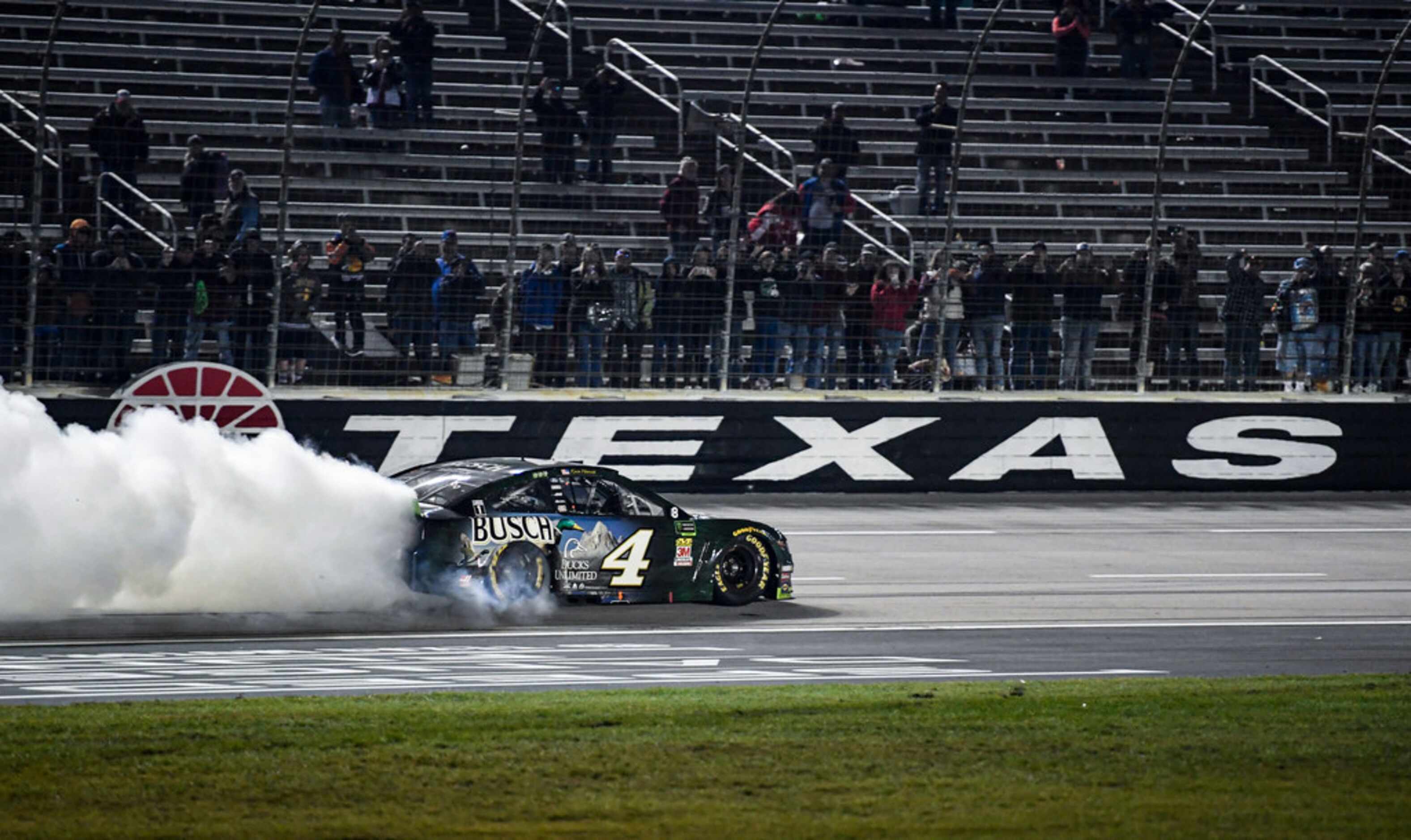 Kevin Harvick (4) celebrates after winning a NASCAR Cup Series auto race with a burnout at...