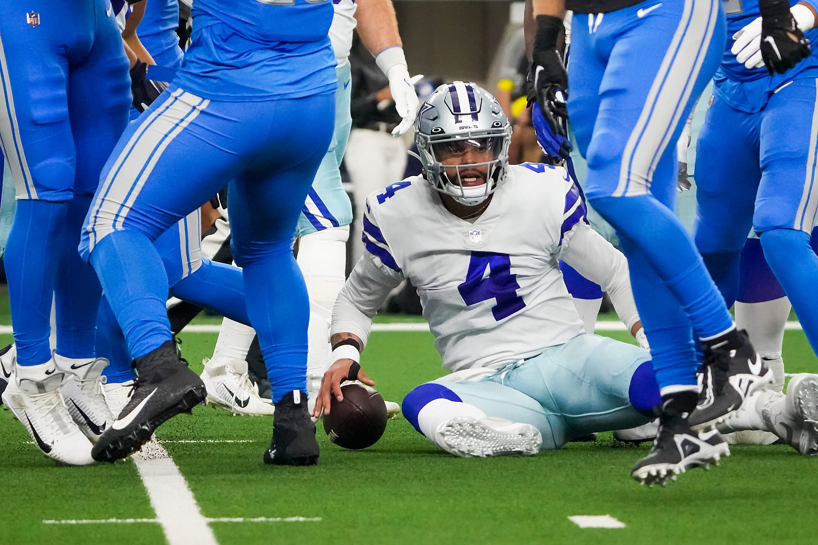 Dallas Cowboys quarterback Dak Prescott looks up after being sacked by Detroit Lions...