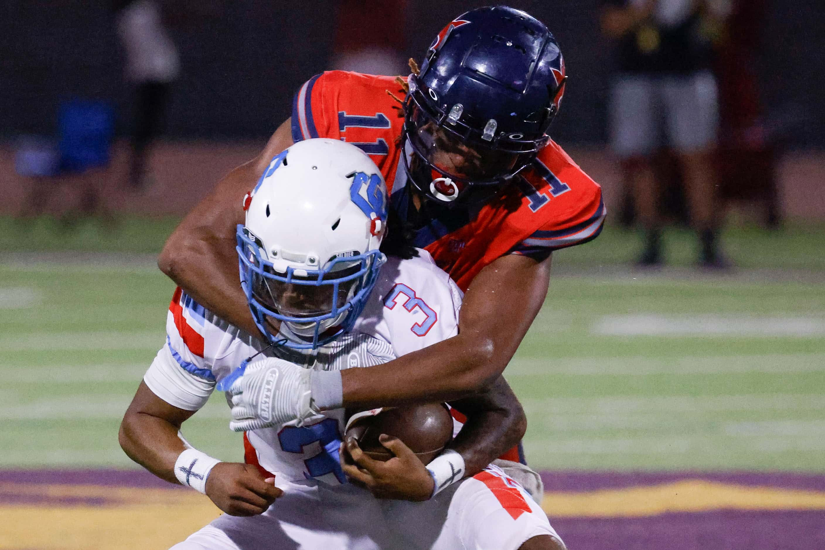 Carter High’s Quaylon Robinson (3) charged by Kimball High’s Tra’von Rhinehart-Grimes during...