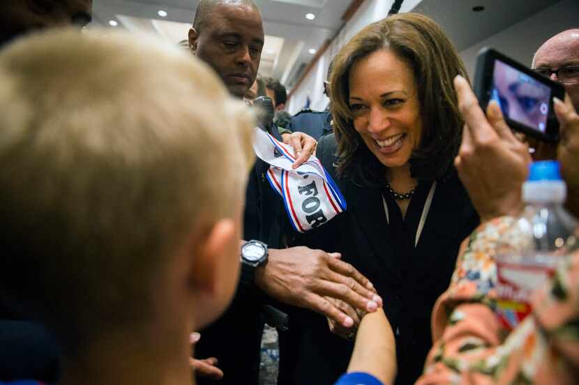 Sen. Kamala Harris (D-California), a Democratic presidential candidate,shakes hands with...