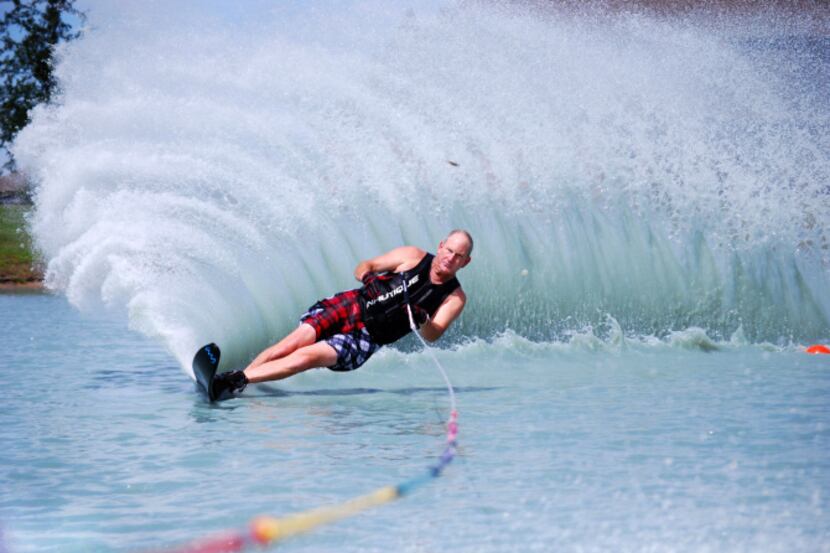 Robert Lacy makes his way around a buoy on a slalom water ski in the Princeton Lakes...
