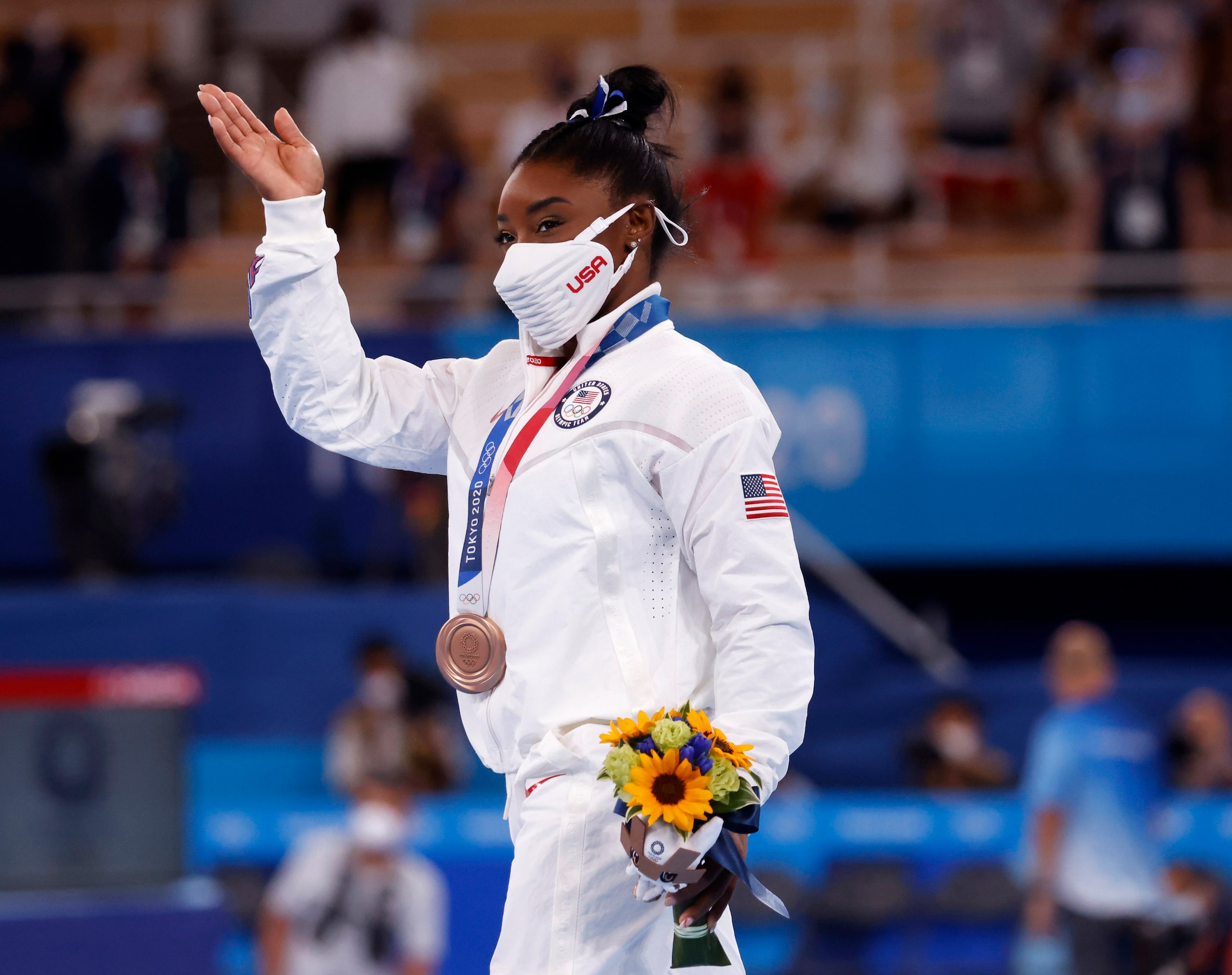 USA’s Simone Biles walks around the stage with her bronze medal during the medal ceremony...