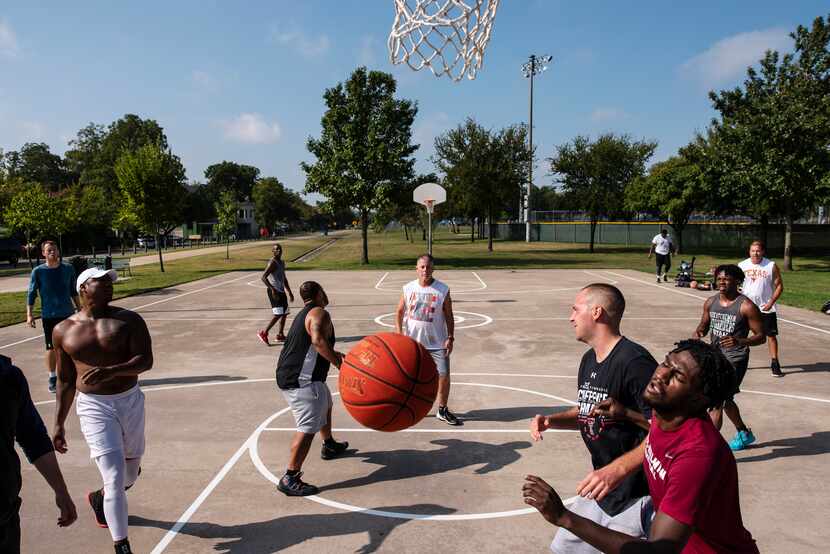 A group of friends play basketball at Willis Winters Park in East Dallas on Saturday, just...