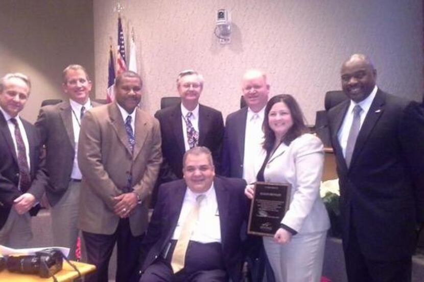 Susan Motley, holding plaque, with Irving Parks and Rec officials, was one of three outgoing...