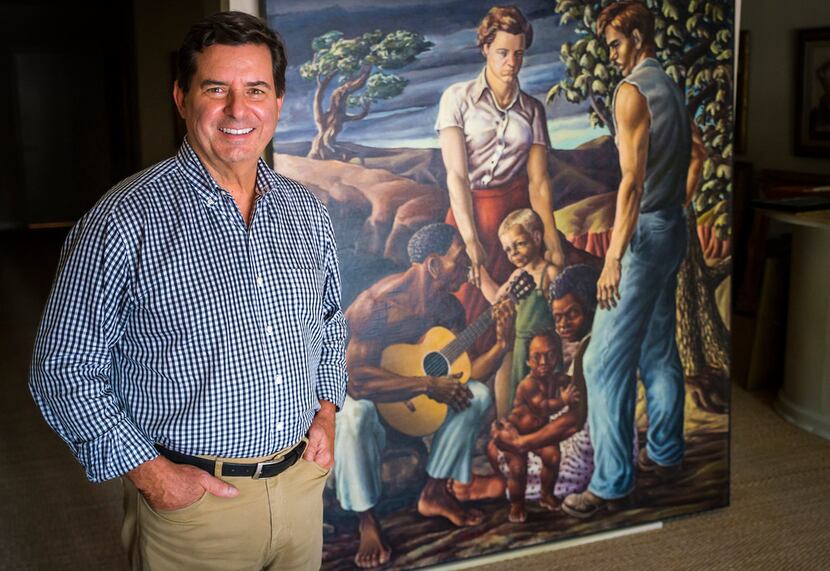 David Dike Fine Art founder and owner David Dike is photographed with a painting by Michael...