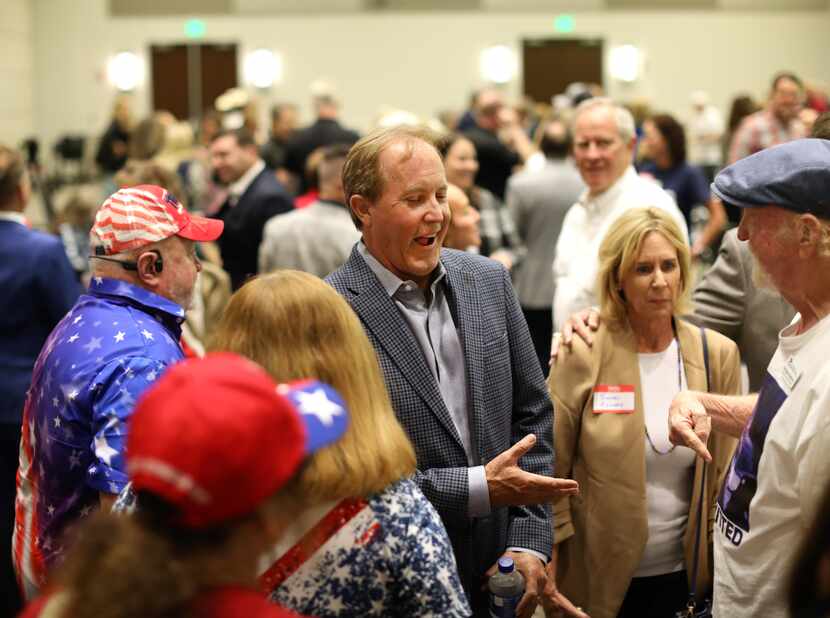 Ken Paxton, center, speaks with supporters during the GOP County Executive Meeting at the...