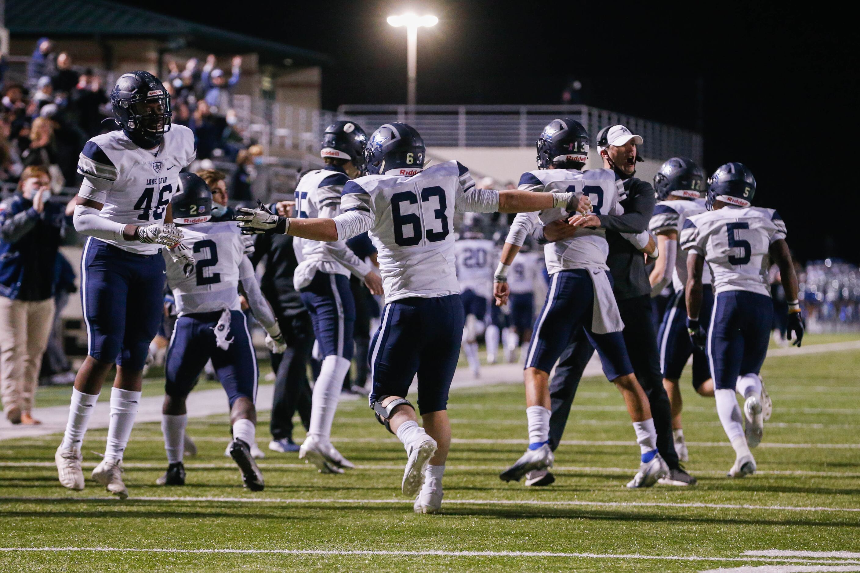 Frisco Lone Star players and coaches celebrate a touchdown during the end of the second...