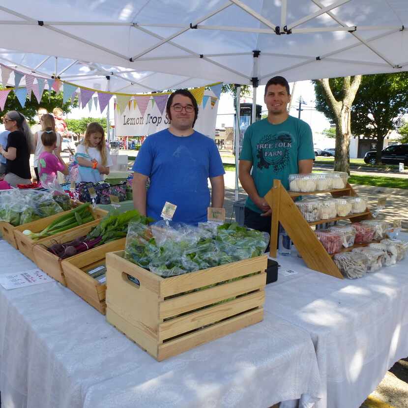 Tree Folk Farm co-owner Matt Gorham from Denton (right) gets a hand from Mark Garza at...