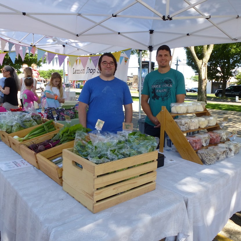 Tree Folk Farm co-owner Matt Gorham from Denton (right) gets a hand from Mark Garza at...