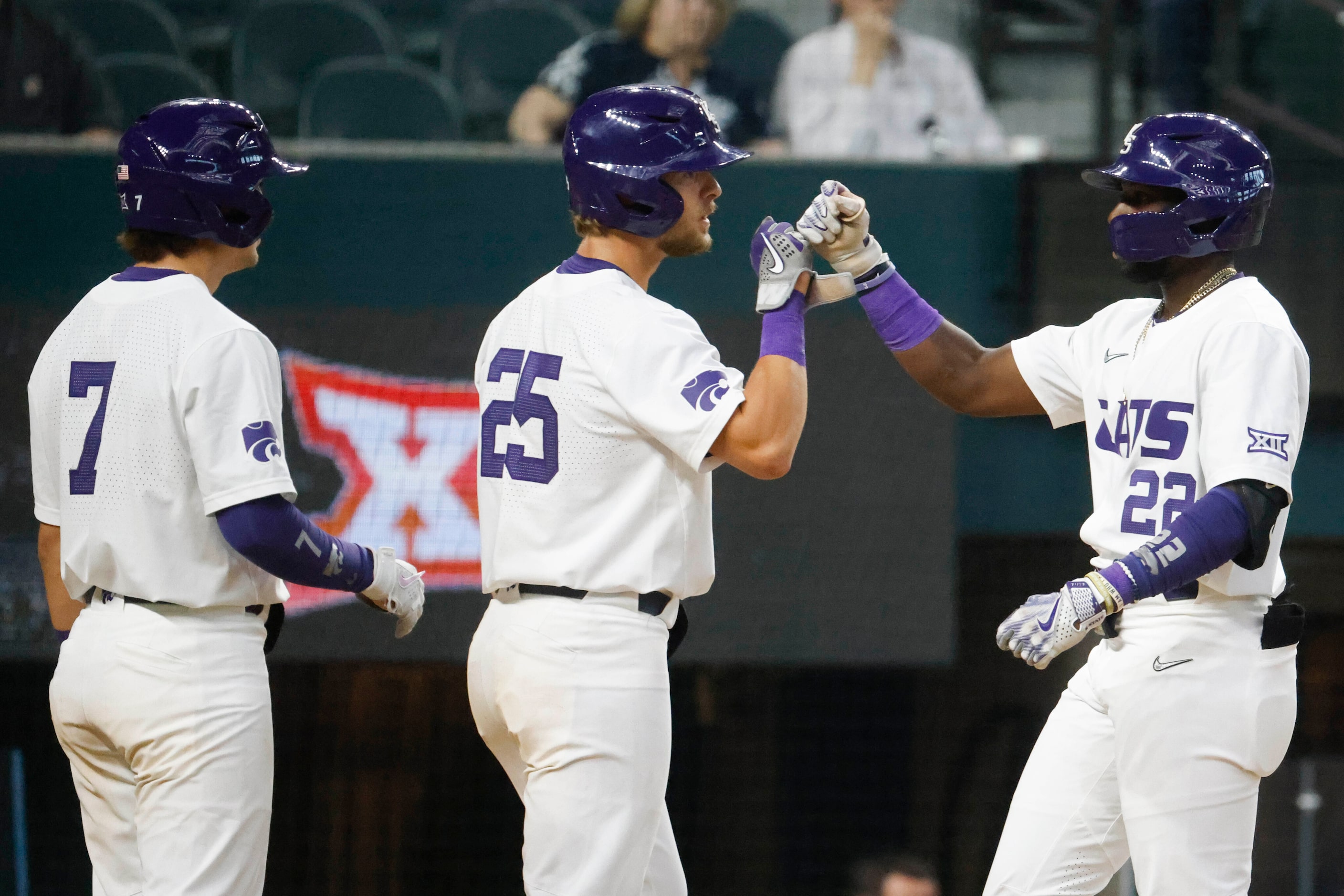 From left, Kansas St. infielders Brady Day and Nick Goodwin cheer with Kaelen Culpepper...