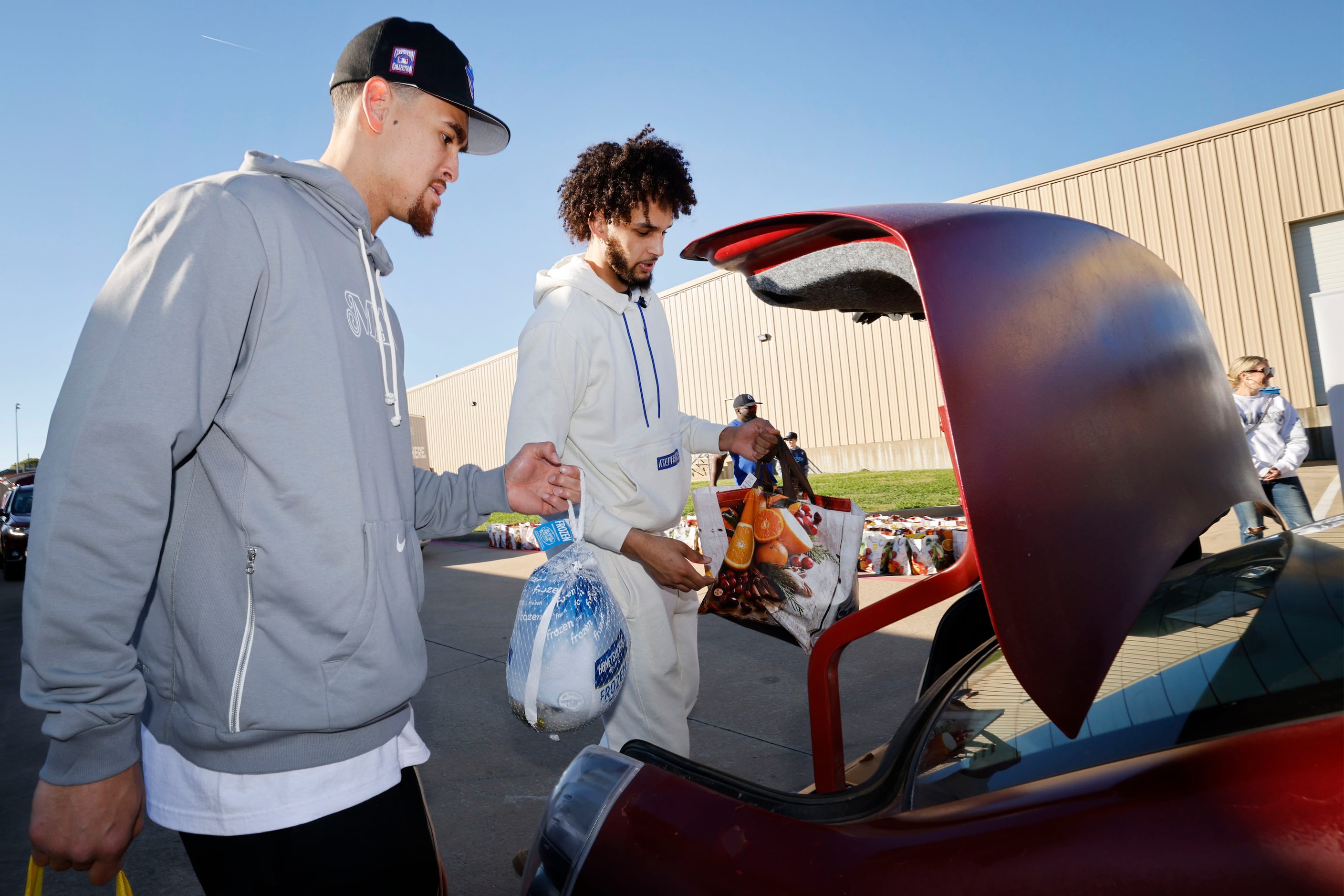 Dallas Mavericks center Dwight Powell, left and Dallas Mavericks center Dereck Lively II...