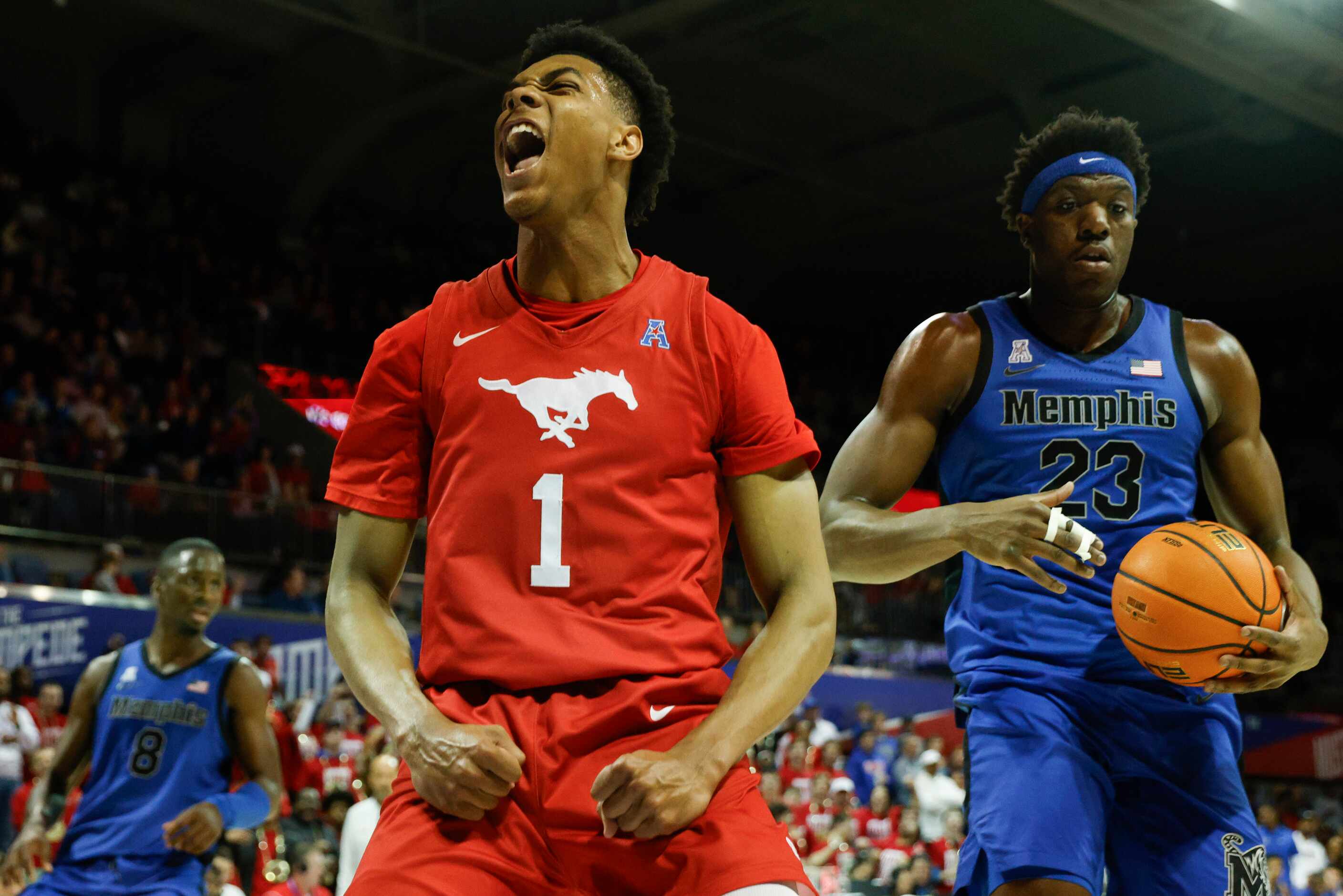 SMU guard Zhuric Phelps (1) flexes after dunking the ball during the second half of an NCAA...