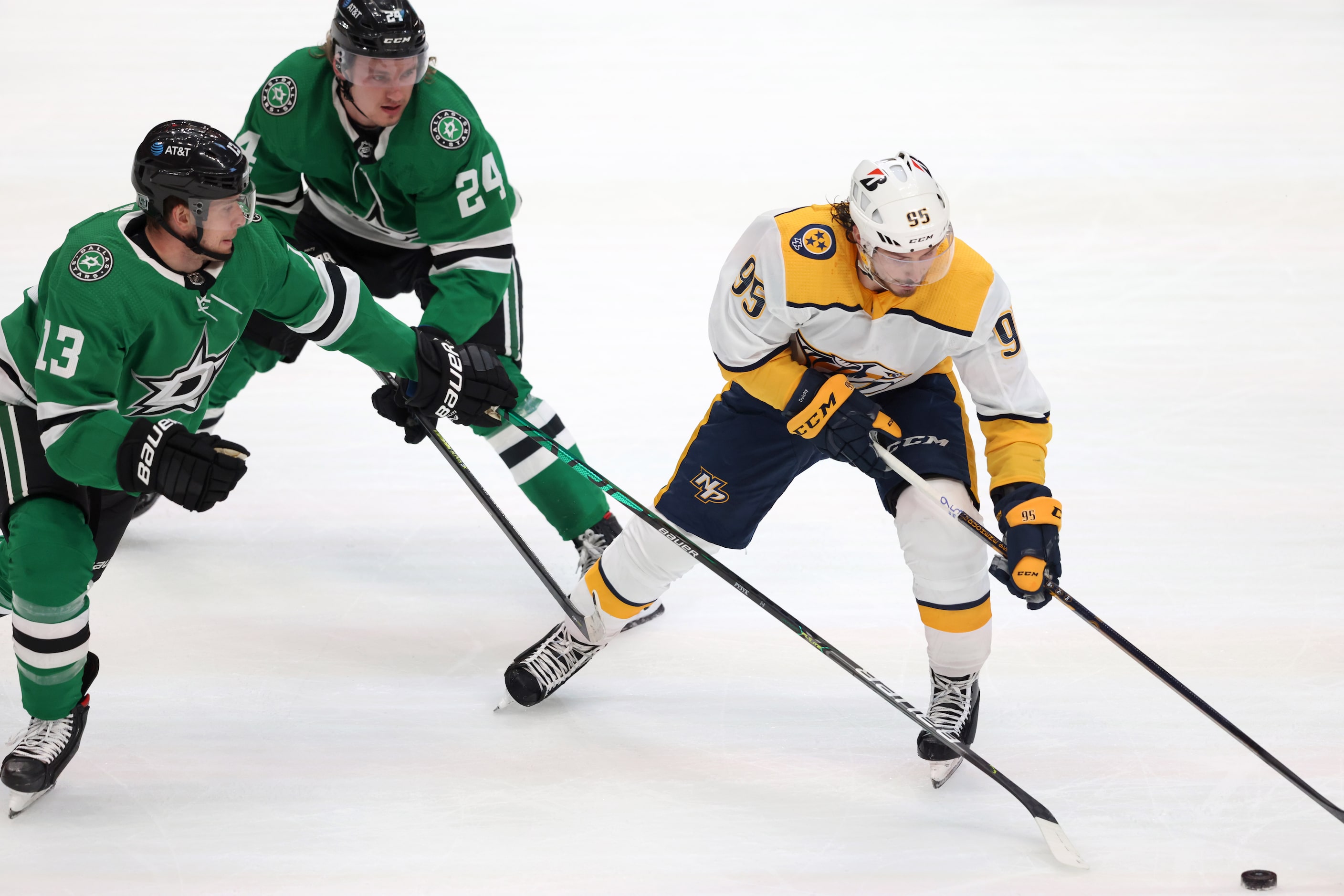 Dallas Stars defenseman Mark Pysyk (13) and Dallas Stars left wing Roope Hintz (24) attempt...