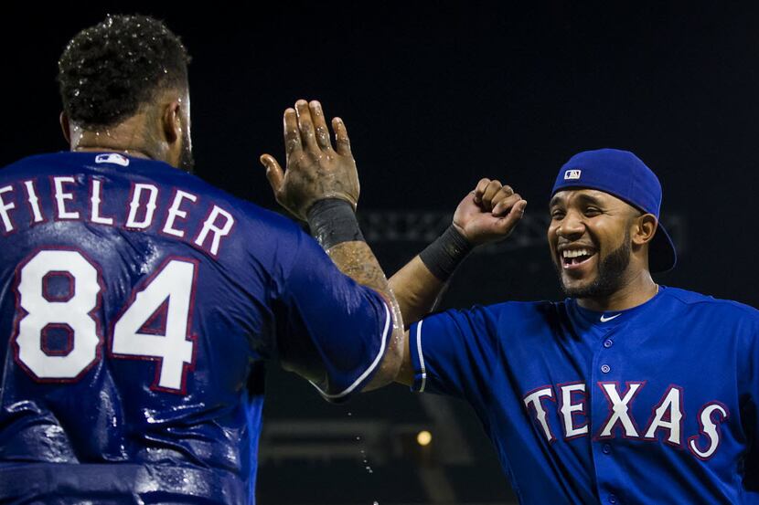 Texas Rangers designated hitter Prince Fielder is celebrates with shortstop Elvis Andrus...
