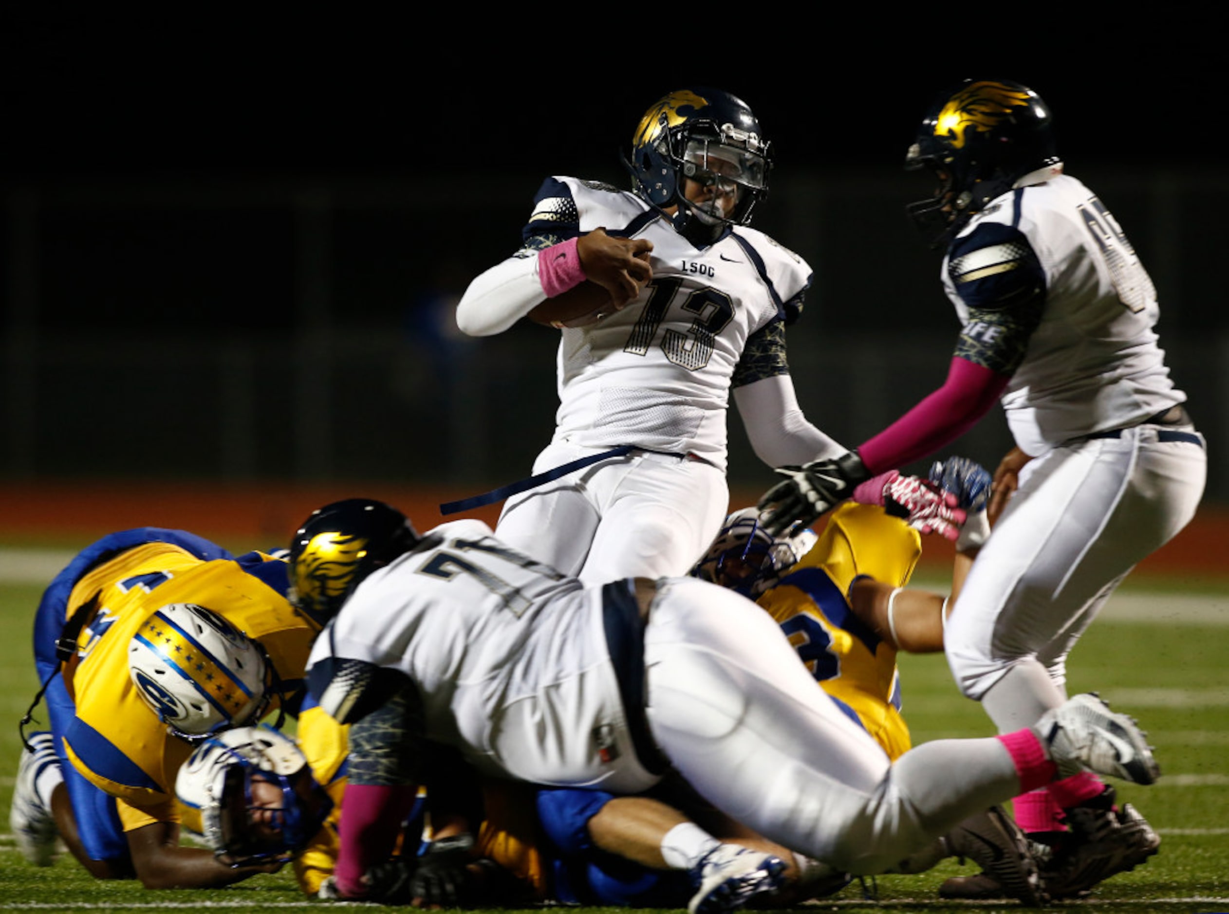 Life Oak Cliff quarterback Chayce Harris is wrapped up against Sunnyvale in the first half...