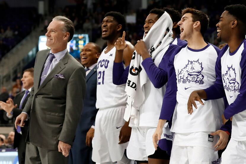 TCU head coach Jamie Dixon, left, Kevin Samuel (21) and the rest of the bench watch in the...