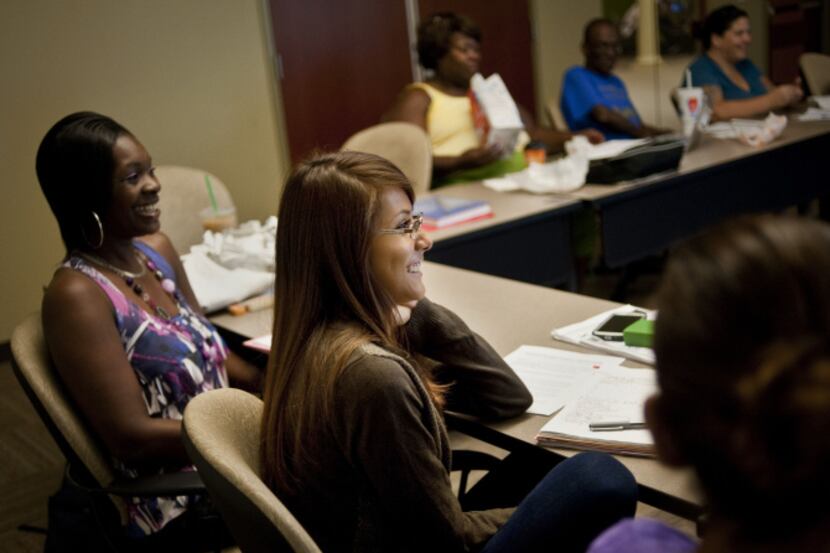 Mariela Torres (center) laughs during a group presentation during a class at Eastfield...