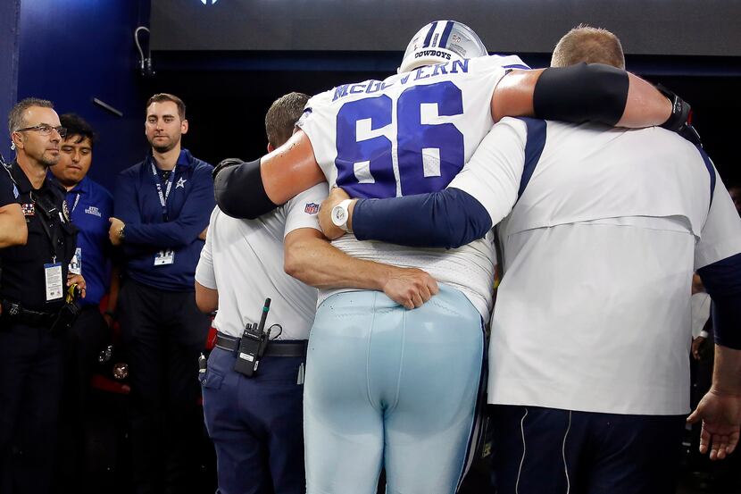 Dallas Cowboys guard Connor McGovern (66) is helped to the locker after sustaining a first...
