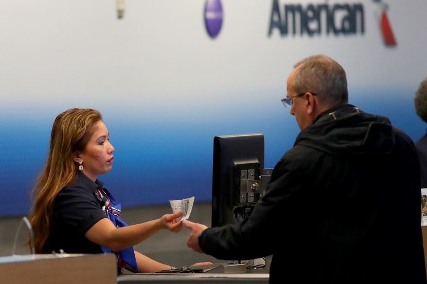 DALLAS, TEXAS - MARCH 13: A passenger checks in for an American Airlines in Terminal D at...