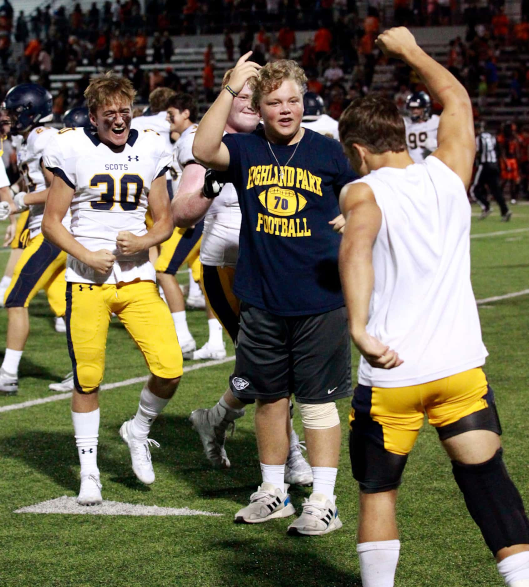 The Highland Park Scots, including James Durand (30) celebrate at the end of their 66-59 win...