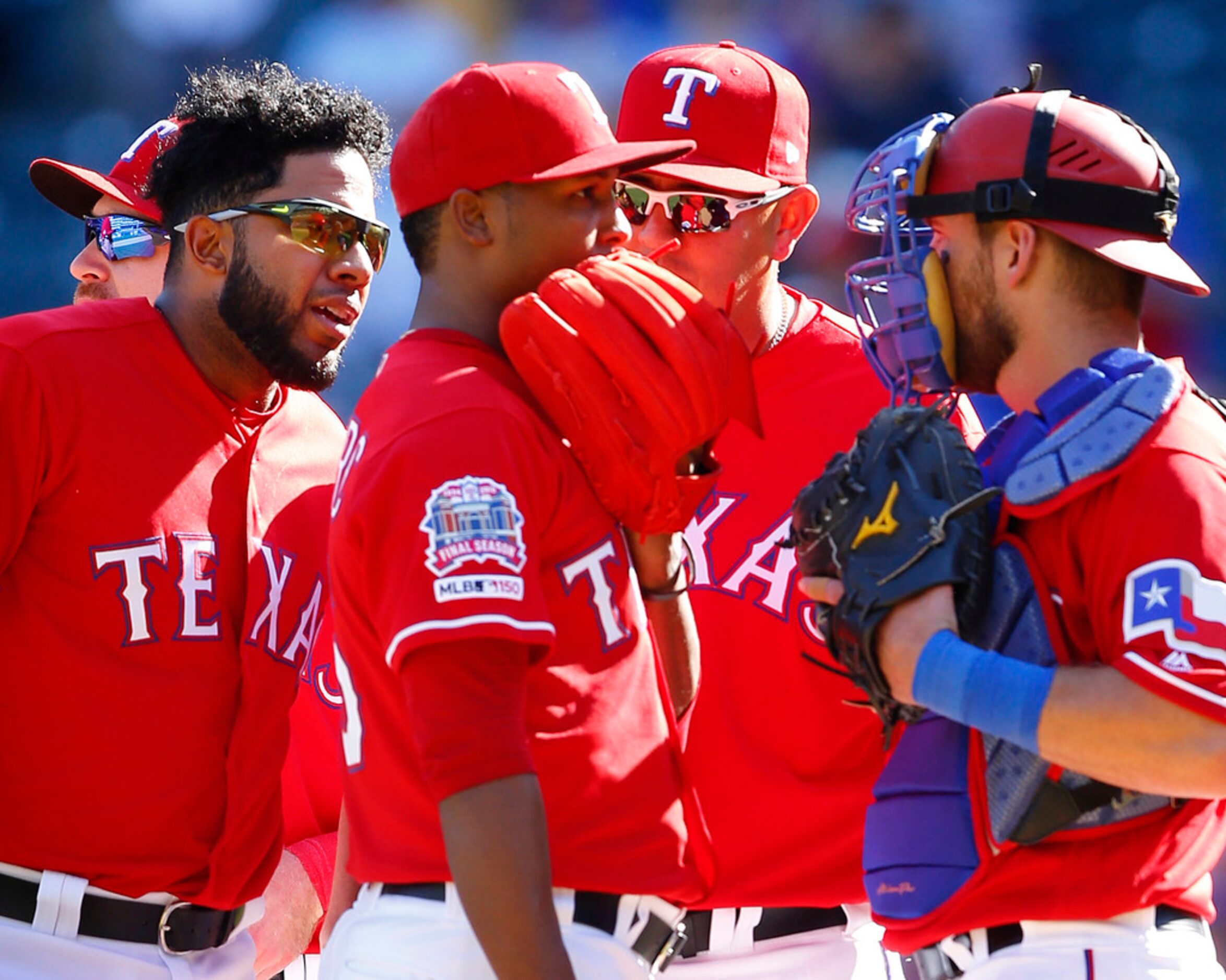 Texas Rangers relief pitcher Jose Leclerc (25) receives an earful from shortstop Elvis...