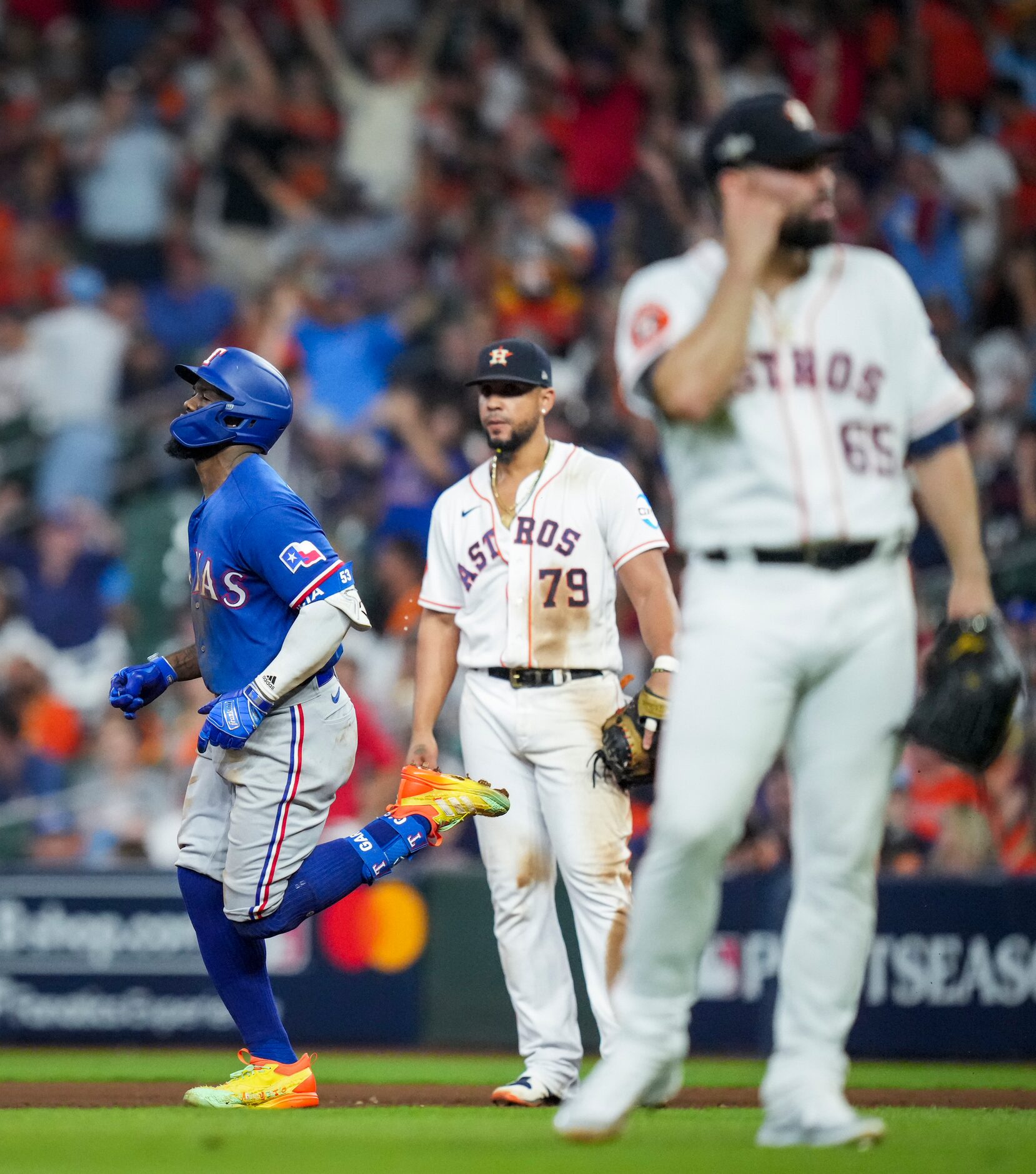 Texas Rangers right fielder Adolis Garcia (53) passes by Houston Astros first baseman Jose...