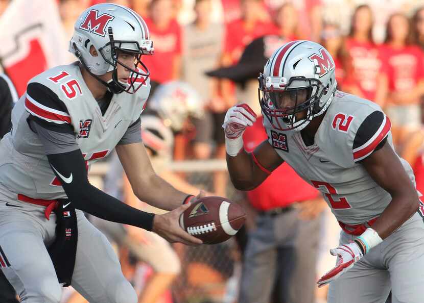 Flower Mound Marcus quarterback Xavier Maxwell (15) hands off the ball to running back...