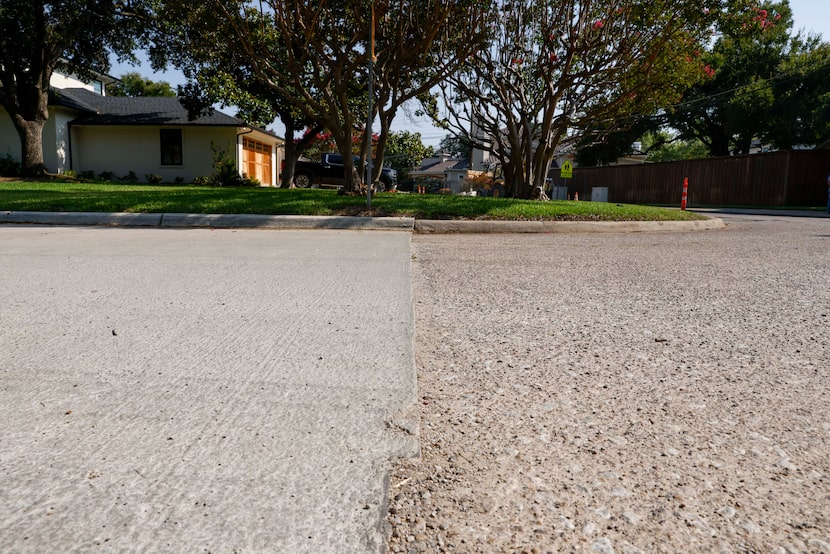 A new “cool pavement” (left) is seen alongside a traditional payment near Drujon Lane and...